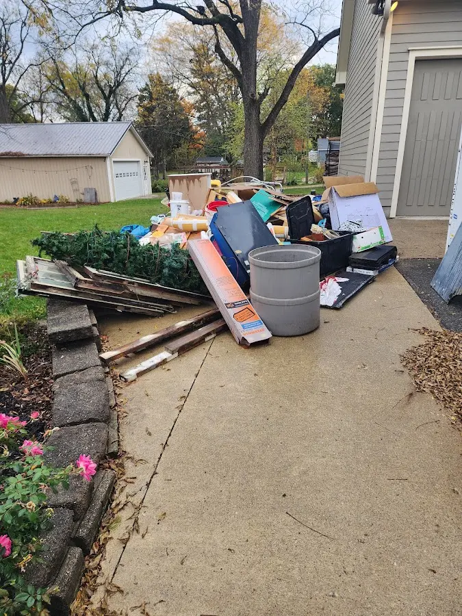Dumpster being loaded with debris for 12 Yard Dumpster Rental in Sidney
